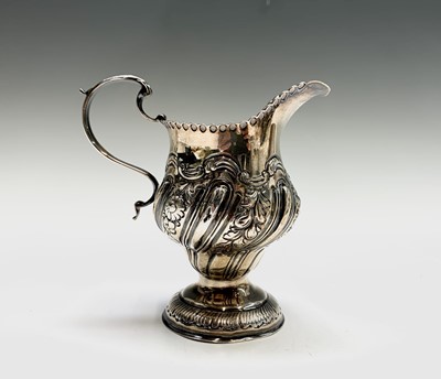 Lot 1015 - An early George III silver cream jug of pear...