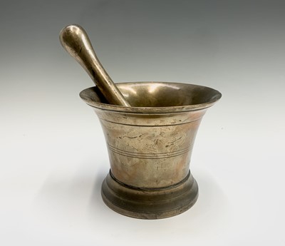 Lot 293 - A bronze mortar and pestle. Height of mortar...