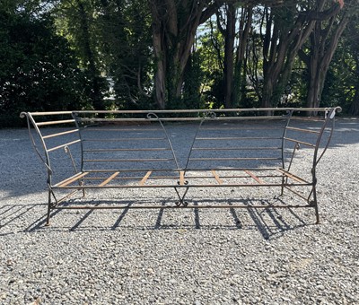 Lot 396 - A wrought iron garden settee with swept arms....