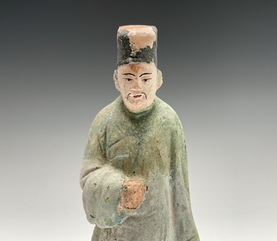 Lot 394 - A Chinese glazed pottery figure of a standing...