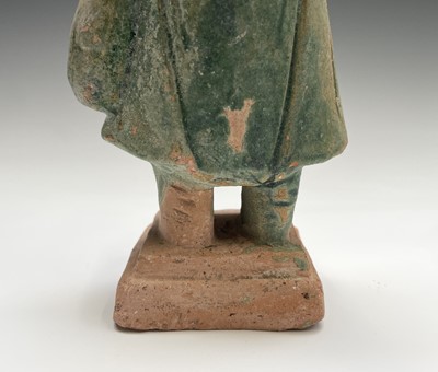 Lot 394 - A Chinese glazed pottery figure of a standing...