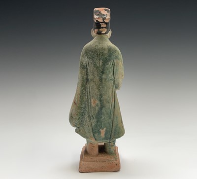 Lot 394 - A Chinese glazed pottery figure of a standing...