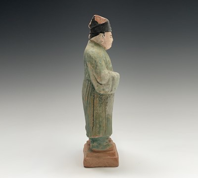 Lot 394 - A Chinese glazed pottery figure of a standing...