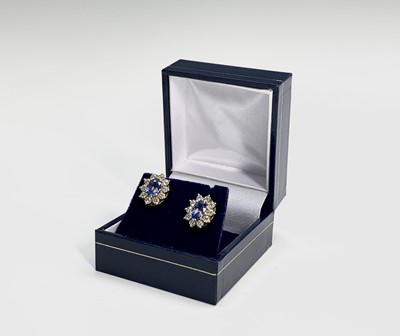 Lot 211 - A pair of good oval pale sapphire and diamond...