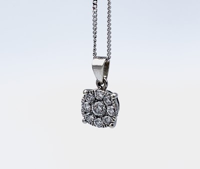 Lot 333 - An all-diamond target cluster pendant in 18ct...
