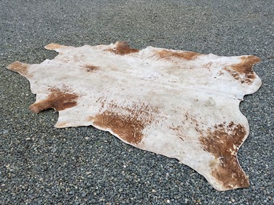 Lot 2875 - A cow hide rug. 238 x 208cm (irregular).