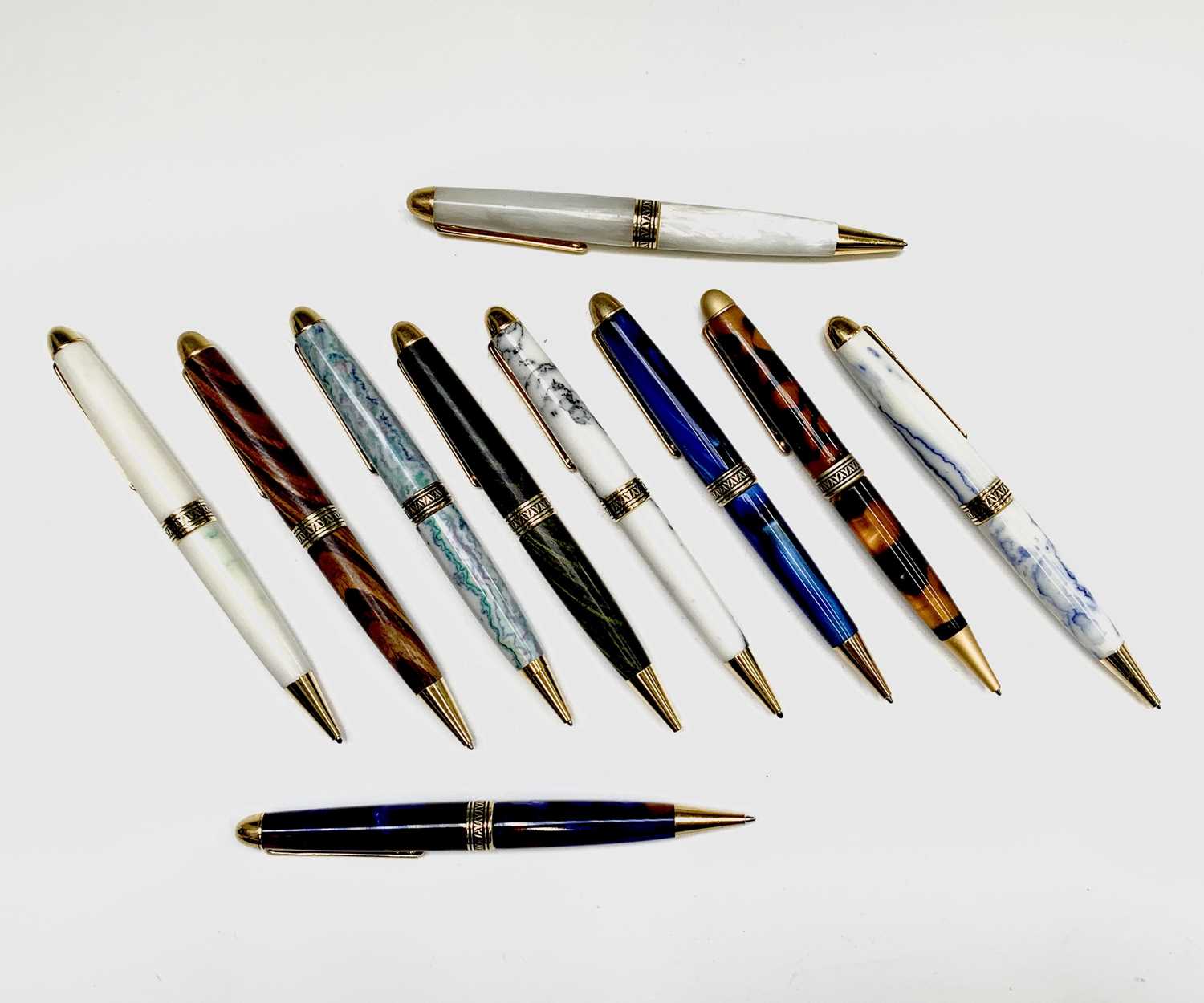 Lot 1121 - Ten ballpoint pens, each has gold plated...