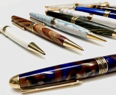 Lot 1121 - Ten ballpoint pens, each has gold plated...