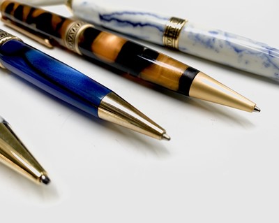 Lot 1121 - Ten ballpoint pens, each has gold plated...