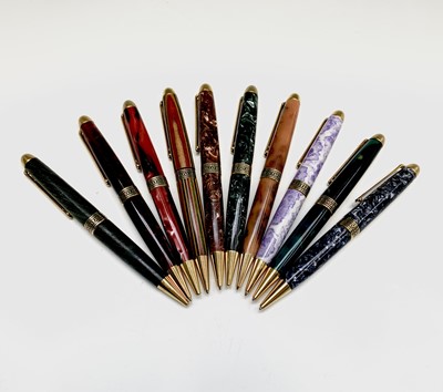 Lot 1122 - Ten ballpoint pens, each has gold plated...