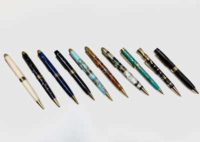 Lot 1123 - Ten ballpoint pens, each has gold plated...