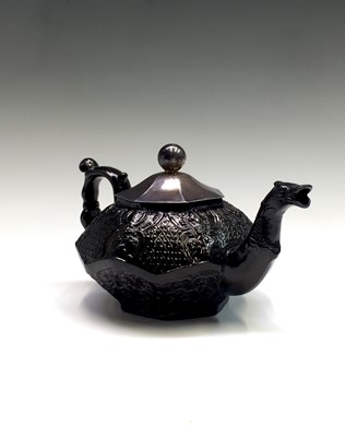 Lot 1140 - A black glazed South Wales Pottery teapot,...