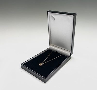 Lot 104 - A yellow sapphire (2.7cts) and diamond pendant...