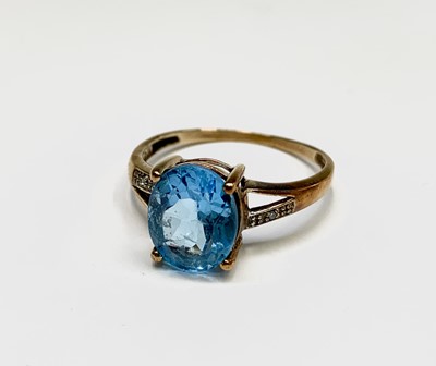Lot 205 - A 9ct gold blue topaz and diamond ring...