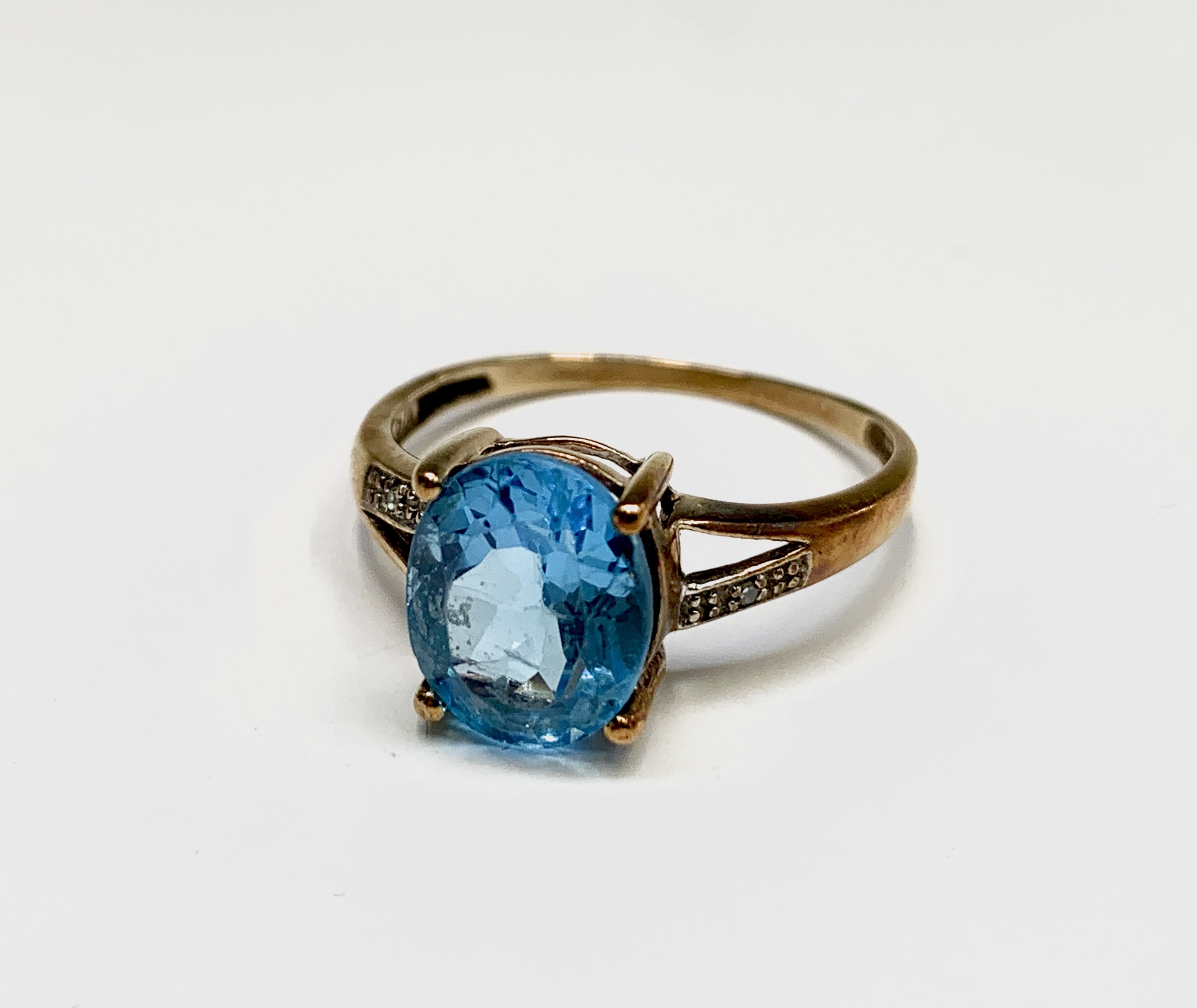 Lot 205 - A 9ct gold blue topaz and diamond ring