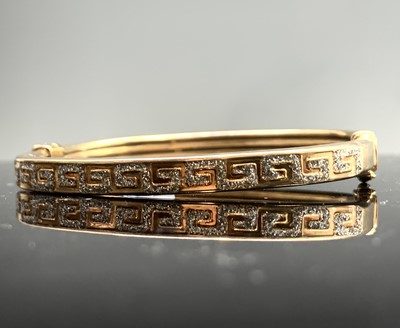 Lot 362 - A 9ct gold Greek key pierced hinged bangle 9.2gm