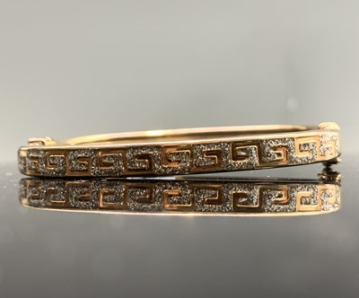 Lot 362 - A 9ct gold Greek key pierced hinged bangle 9.2gm