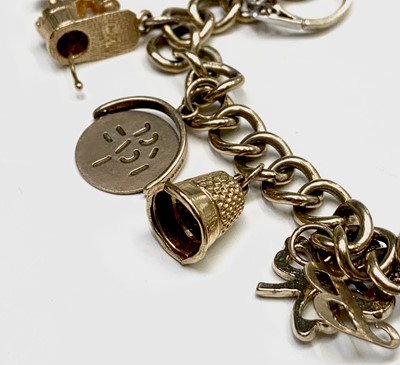 Lot 132 - A 9ct gold charm bracelet 29.9gm