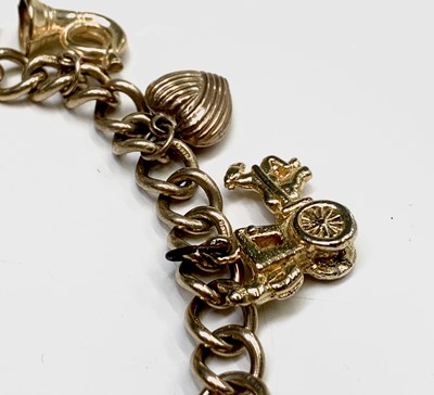 Lot 132 - A 9ct gold charm bracelet 29.9gm