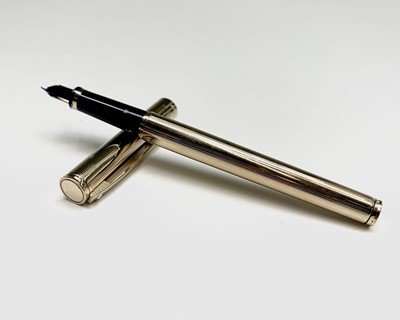 Lot 1230 - A Sheaffer Agio compact gold fountain pen and...