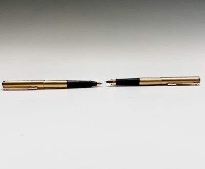 Lot 1230 - A Sheaffer Agio compact gold fountain pen and...