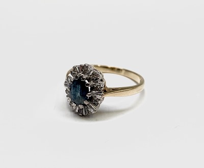 Lot 409 - An 18ct gold ring with an oval sapphire and...