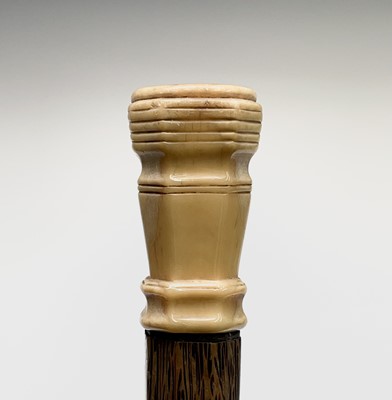Lot 73 - An Art Deco palm wood walking cane, with...