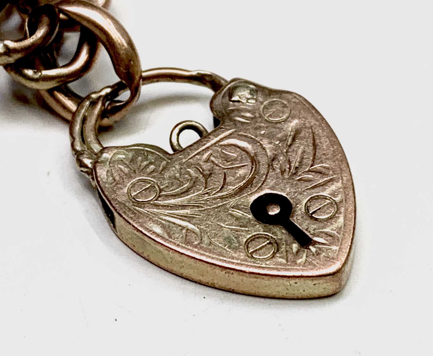 Lot 197 - A 9ct gold curb link bracelet with padlock...