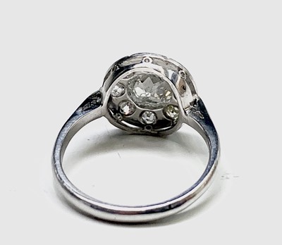 Lot 35 - A white gold or platinum ring with a circular...
