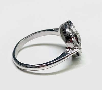 Lot 35 - A white gold or platinum ring with a circular...