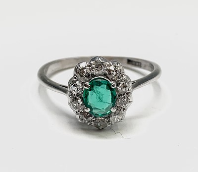 Lot 27 - An 18ct white gold emerald and diamond oval...
