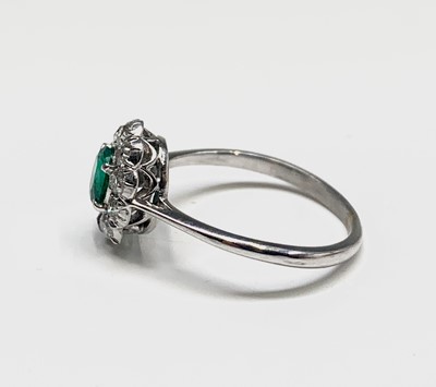 Lot 27 - An 18ct white gold emerald and diamond oval...