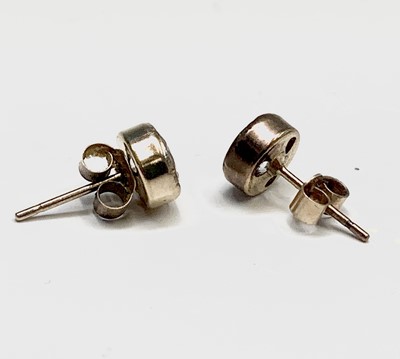 Lot 171 - A pair of white stone set ear studs