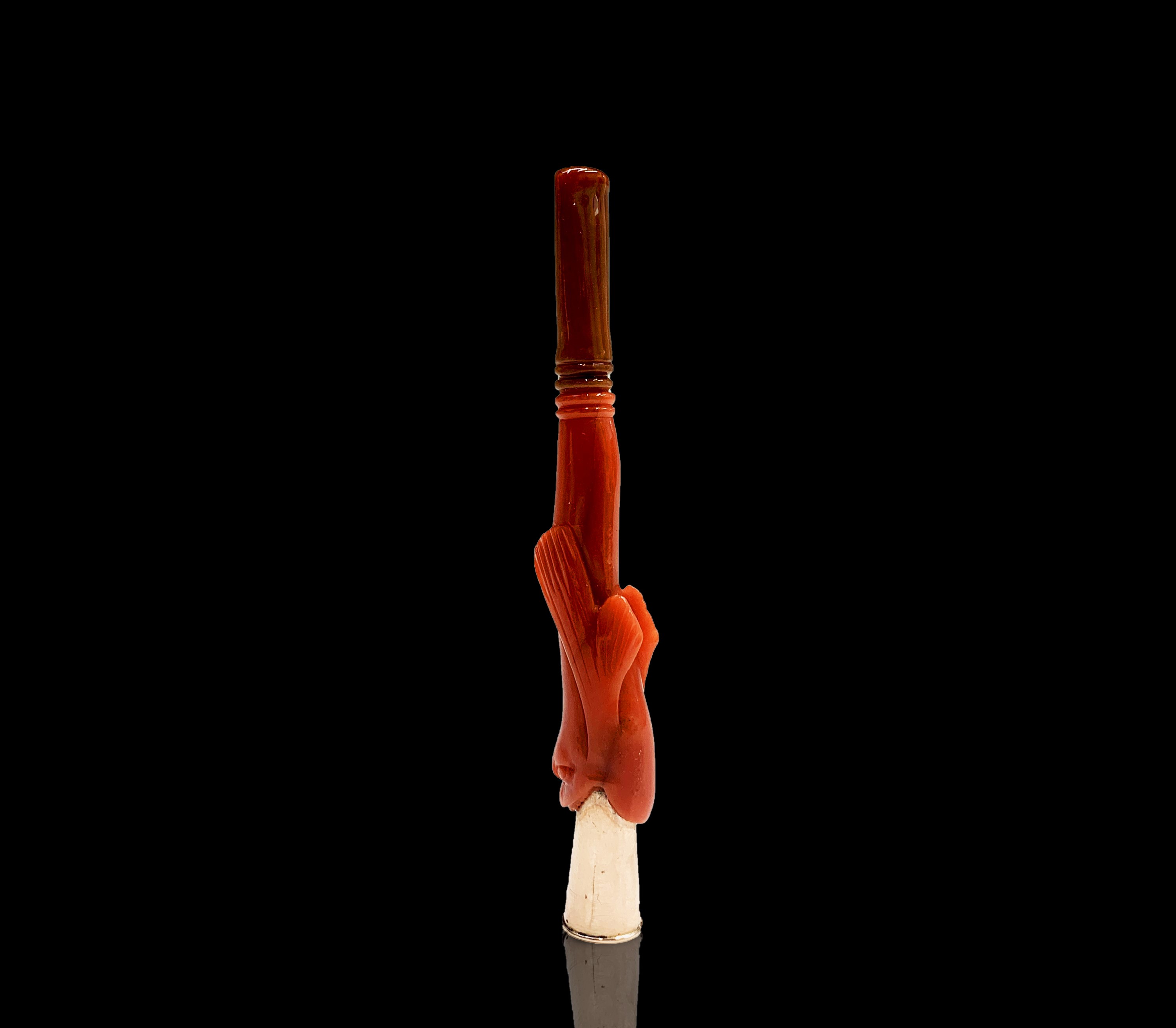Lot 30 - A gold cheroot holder in the mouth of a red