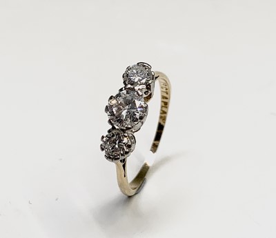 Lot 351 - An 18ct yellow gold and platinum trilogy ring...