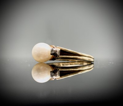Lot 8 - A pretty14ct ring, set a pearl with two tiny...
