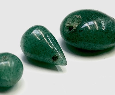 Lot 102 - Three unmounted jade teardrops and a jade bead...