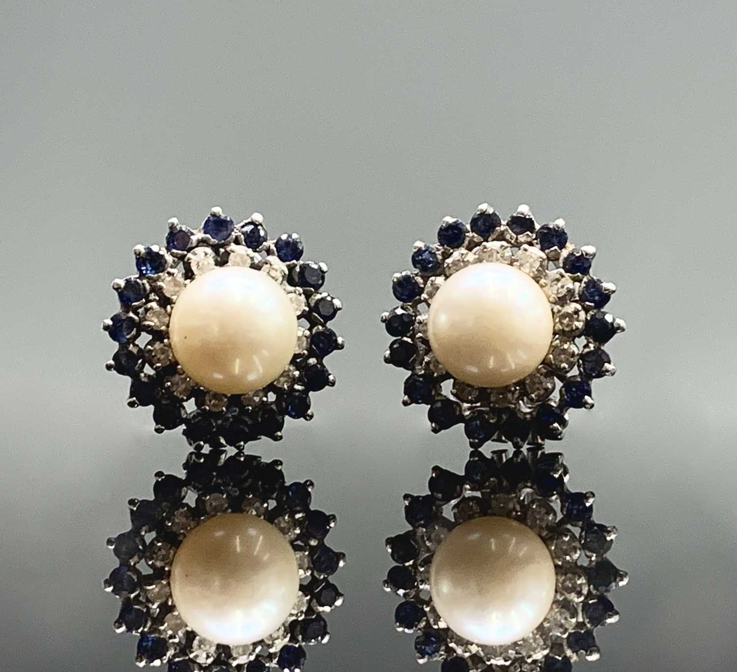 Lot 80 - A pair of 18ct white gold earrings each with a...