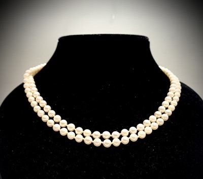 Lot 73 - A double-strand pearl necklace with 14ct...