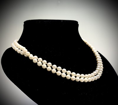 Lot 73 - A double-strand pearl necklace with 14ct...