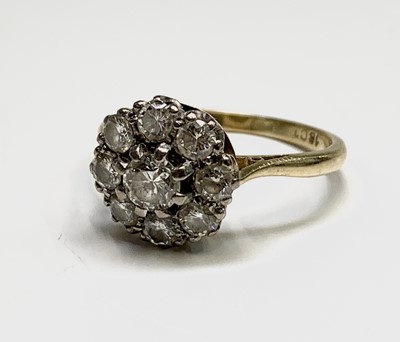 Lot 202 - An 18ct gold ring set a bright nine stone...