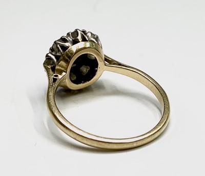 Lot 202 - An 18ct gold ring set a bright nine stone...