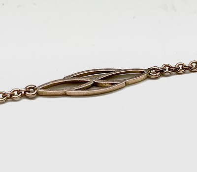 Lot 418 - A delicate gold necklace with spaced pierced...