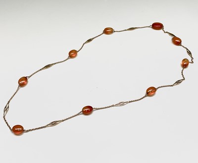 Lot 418 - A delicate gold necklace with spaced pierced...