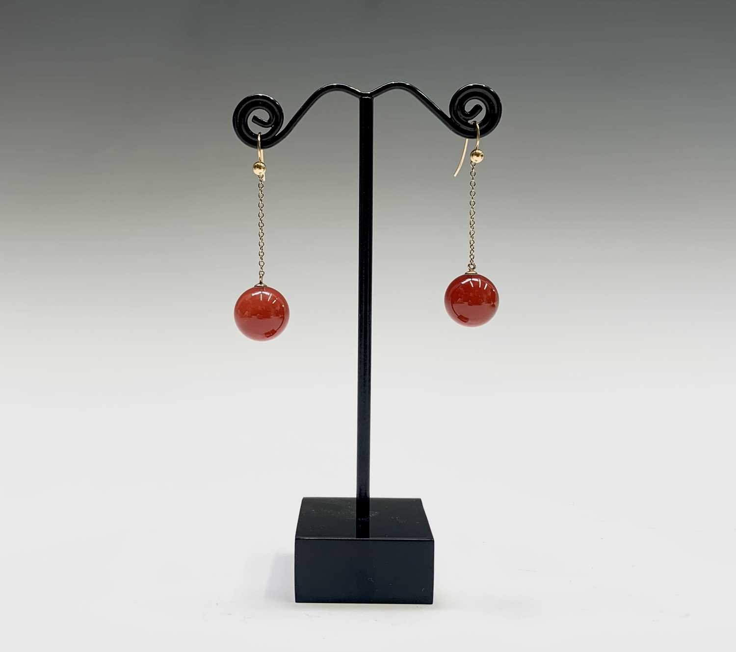 Lot 60 - A pair of gold mounted carnelian bead earrings...