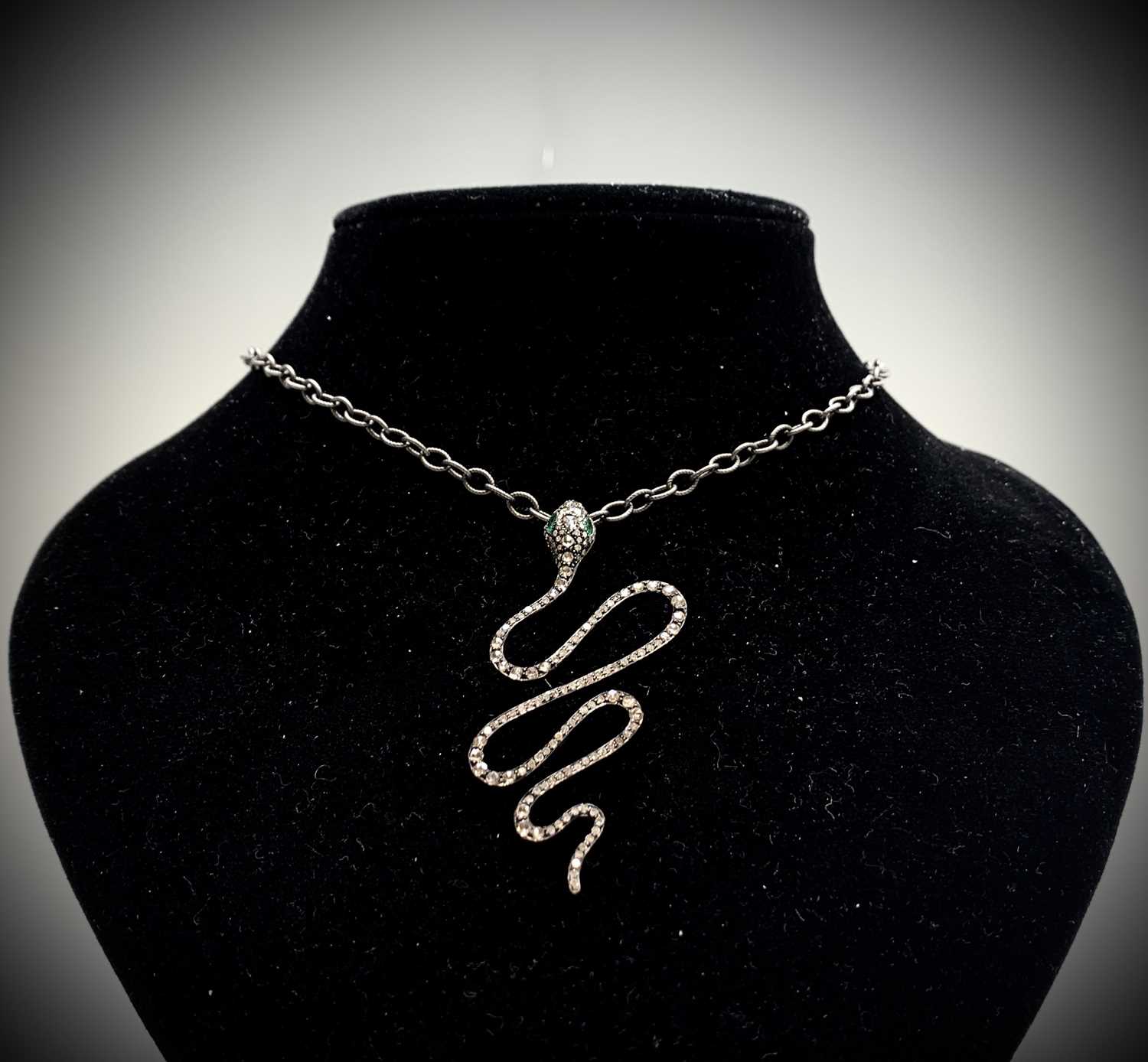 Lot 294 - A serpent pendant with rose diamonds along its...