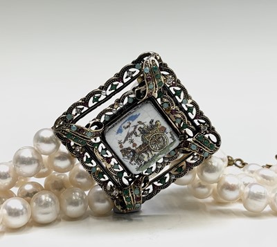Lot 424 - A four strand pearl bracelet with square...