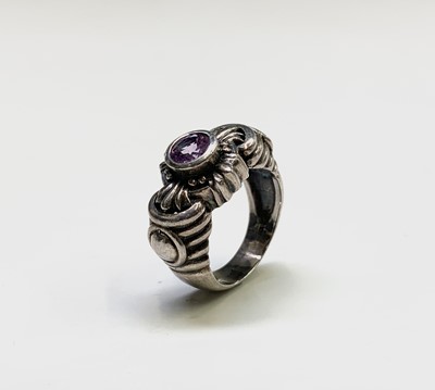 Lot 190 - A modern silver ring with an amethyst in...