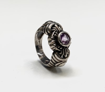 Lot 190 - A modern silver ring with an amethyst in...