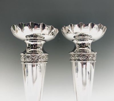 Lot 1010 - A pair of silver vases, the necks with chased...
